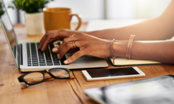 A female work from home data entry clerk working at home on her laptop