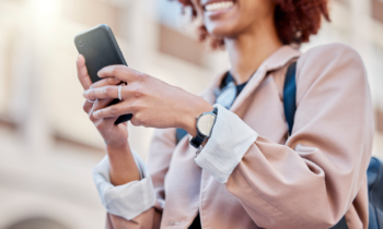 Woman working her mobile phone job on the street